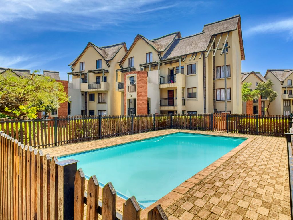 Apartment building pool behind a privacy fence