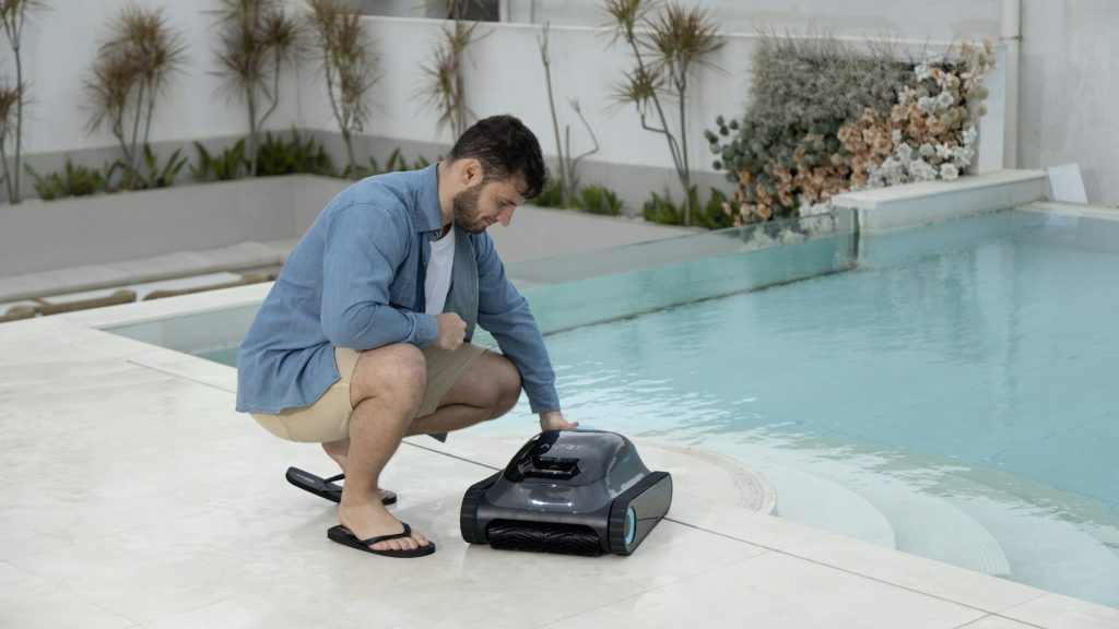 Setting up an automatic pool cleaner at the pool edge