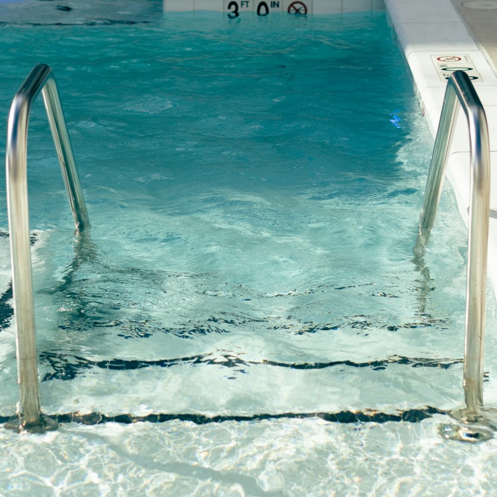 Clean pool steps with stainless handrails