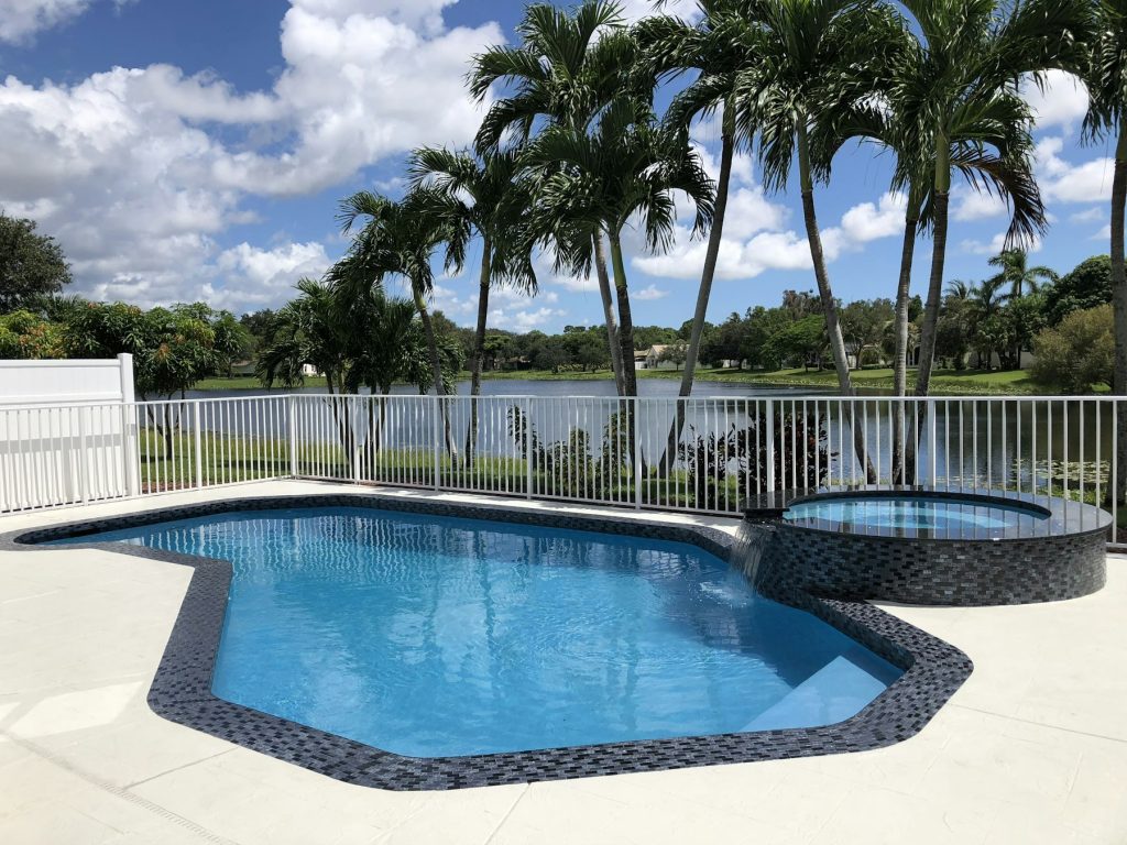 Kidney-shaped pool and spa framed by palm trees