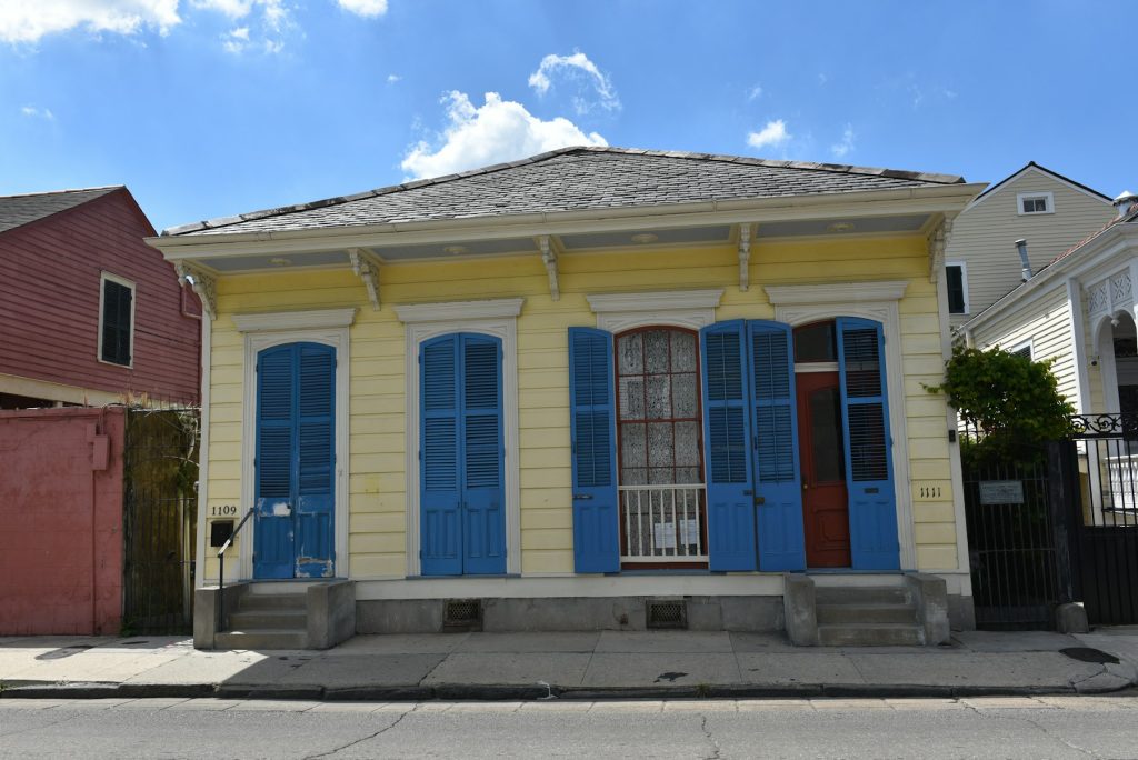 Louisiana shotgun house with blue shutters