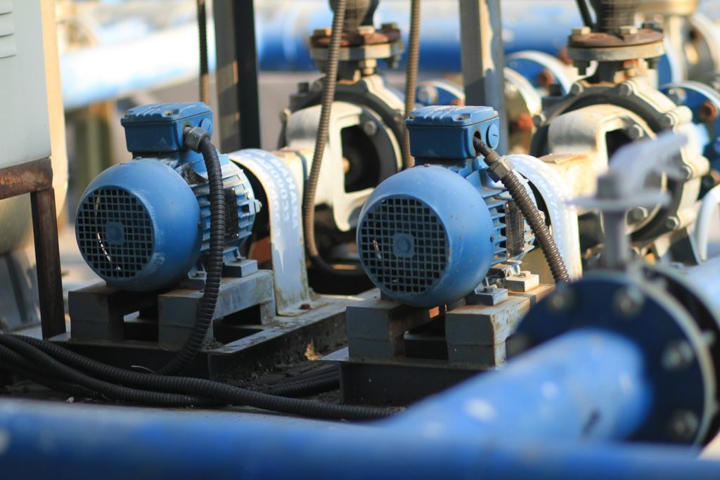 Pump motors and plumbing on a pool equipment pad