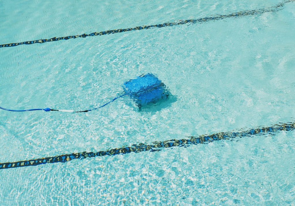 Robotic pool vacuum cleaning the pool floor