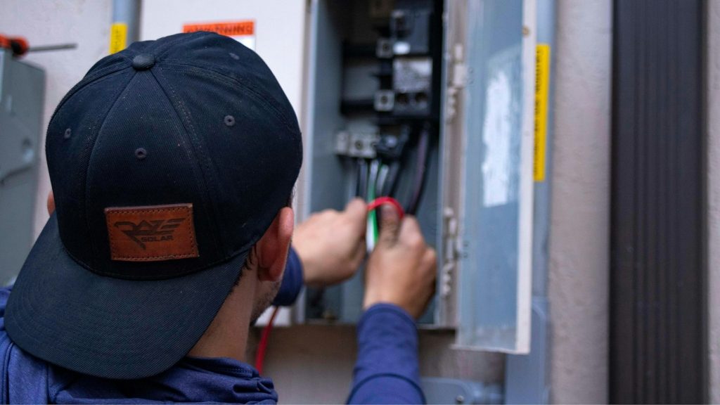 Technician servicing an electrical panel